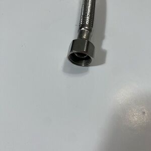 Flexible faucet supply hose 3/8-inch compression fitting on one end and 1/2-in